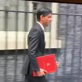 Rishi Sunak leaves Downing Street in 2020 with a burgundy coloured ring binder.
