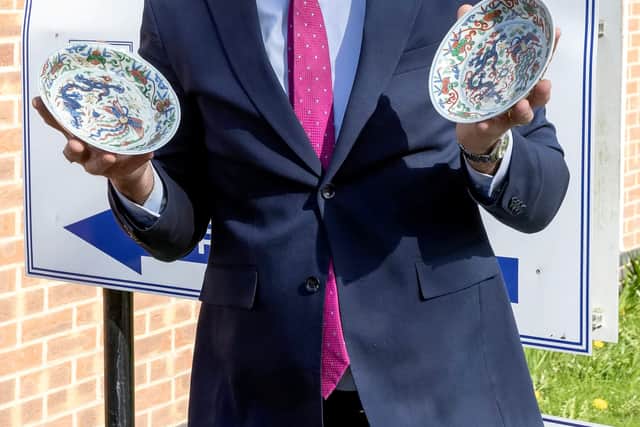 Charles Hanson, owner of Hansons Auctioneers, with two Chinese dragon dishes, part of a set of four which sold for £63,000.