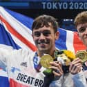 Gold medallists Britain's Thomas Daley (L) and Britain's Matty Lee poses with their medals after wining the men's synchronised 10m platform diving final event during the Tokyo 2020 Olympic Games (Photo by Oli SCARFF / AFP) (Photo by OLI SCARFF/AFP via Getty Images)