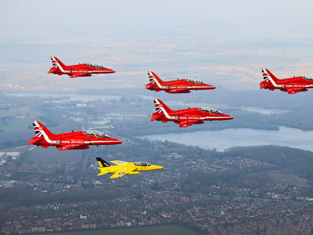 The Red Arrows fly alongside a Yellow Jack