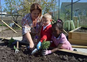 Deputy head Penny Lupton with youngsters in the new eco-garden.