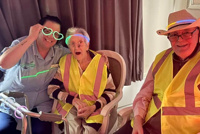Staff member Lois with residents Sheila and Peter.