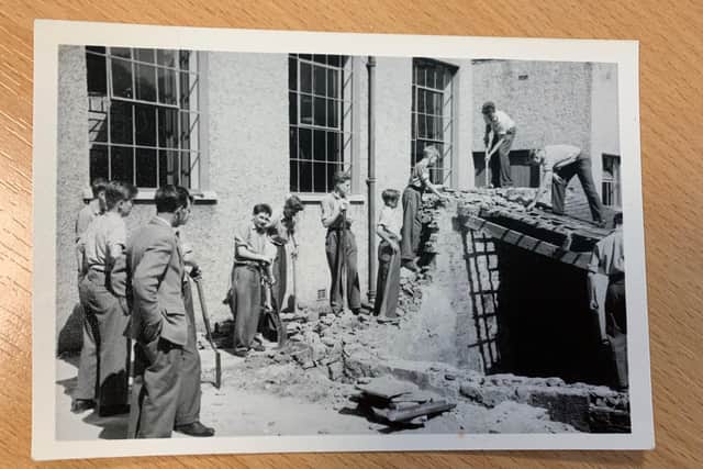 Bentham Grammar School. Boys in action, jackets off for demolition. Picture courtesy of Bentham Grammar School.