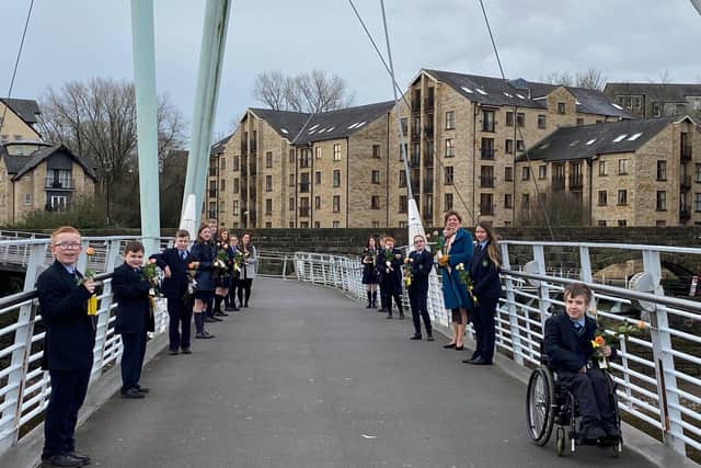 Pupils from Our Lady's Catholic College celebrated Random Acts of Kindness Day by handing out flowers to members of the public on Millennium Bridge.