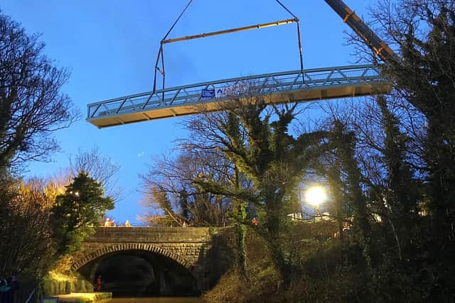 Reader Michael Lamb sent us this photo of the new footbridge being lowered into position.