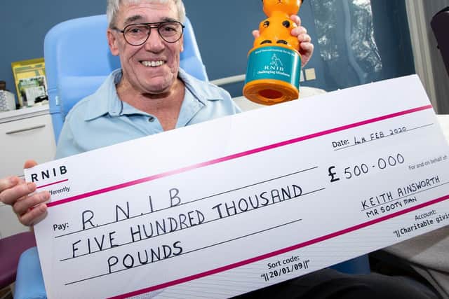 'Sooty Man' Keith Ainsworth with his cheque and Sooty collection tin. Photo: Kelvin Stuttard