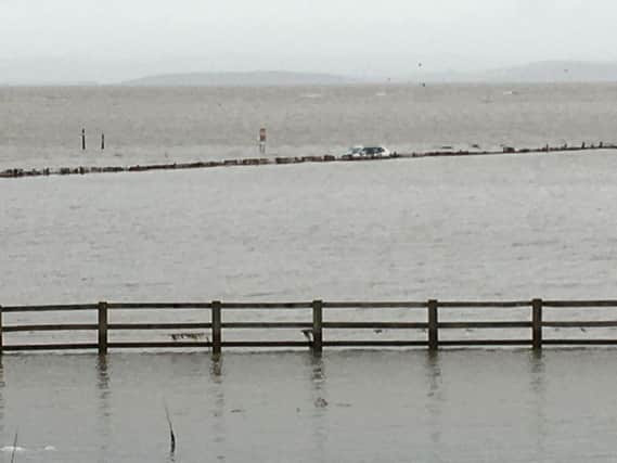 This photo by Morecambe Coastguard shows the car at the scene.