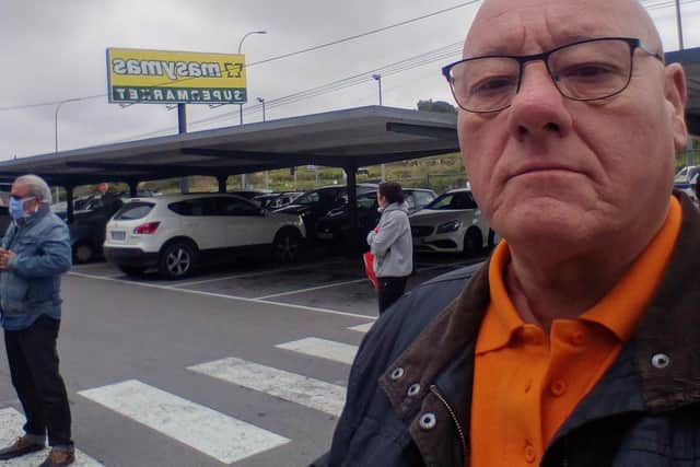 Mick Dennison outside a supermarket in Spain where people have to keep their distance in queues