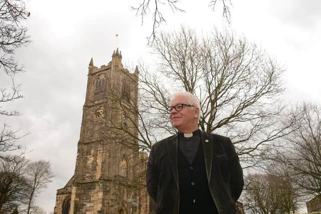 Vicar of Lancaster, Canon Chris Newlands outside Lancaster Priory Church.