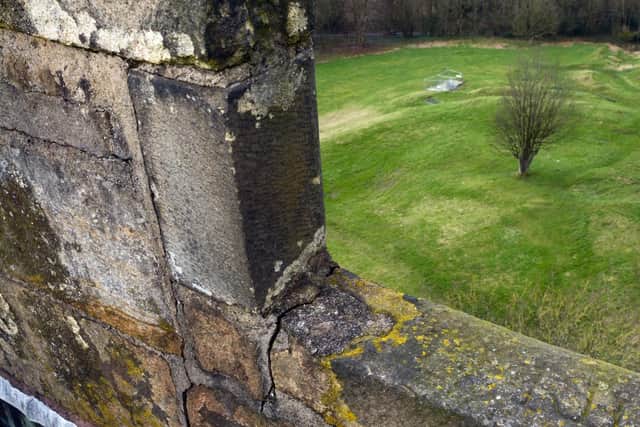 Ageing mortar and precarious stone work at the top of the Priory Church tower.