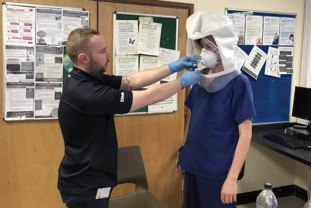 Adam Corcoran-Birtles fits masks to frontline staff.