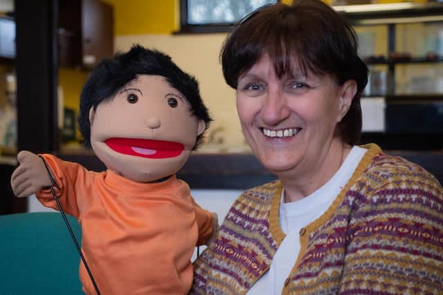 Barton Road Centre community co-ordinator Denise Nardone with Mojo the puppet, who's playing a starring role on the centre's website during the pandemic