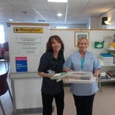 Two members of staff at Royal Lancaster Infirmarys eye clinic receive cakes from Brew Me Sunshine, in Morecambe.