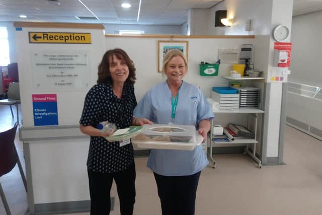 Two members of staff at Royal Lancaster Infirmarys eye clinic receive cakes from Brew Me Sunshine, in Morecambe.