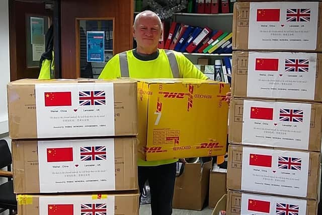 Chris Taylor, a City Council HGV driver from the Waste and Refuse Department unloads the boxes of masks.