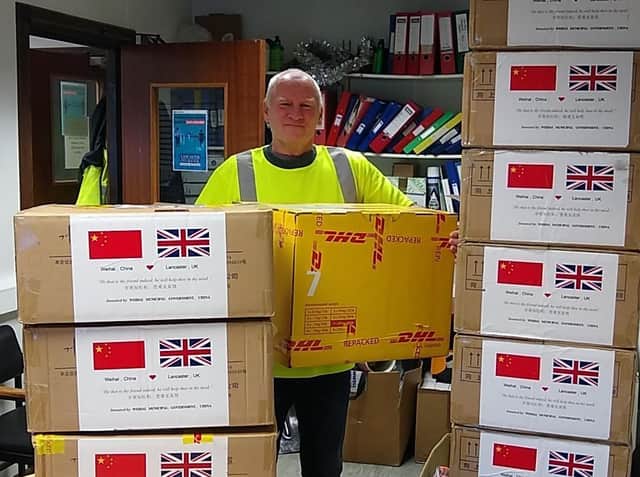 Chris Taylor, a City Council HGV driver from the Waste and Refuse Department unloads the boxes of masks.