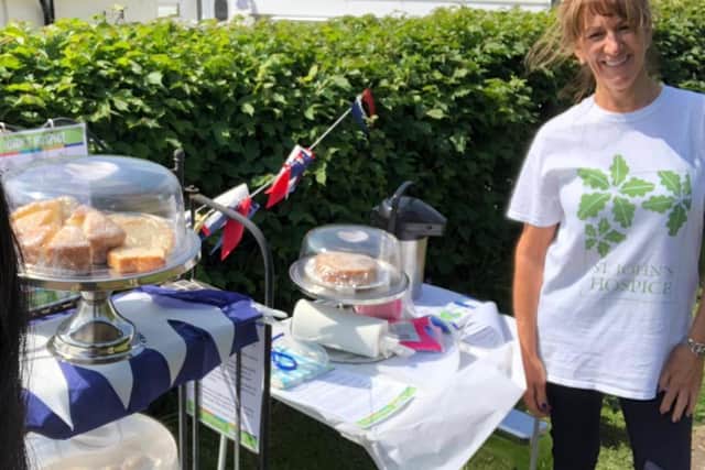 Julie dons her St Johns Hospice T-shirt to prepare the cake stall.