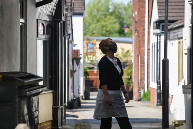 A woman wearing a mask in the  market town of Garstang on Saturday, May 9, 2020, a day before Boris Johnson announced changes to the coronavirus lockdown which has affected all of our lives Daniel Martino for JPIMedia