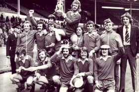 Morecambe players celebrate at Wembley with their FA Trophy in 1974.