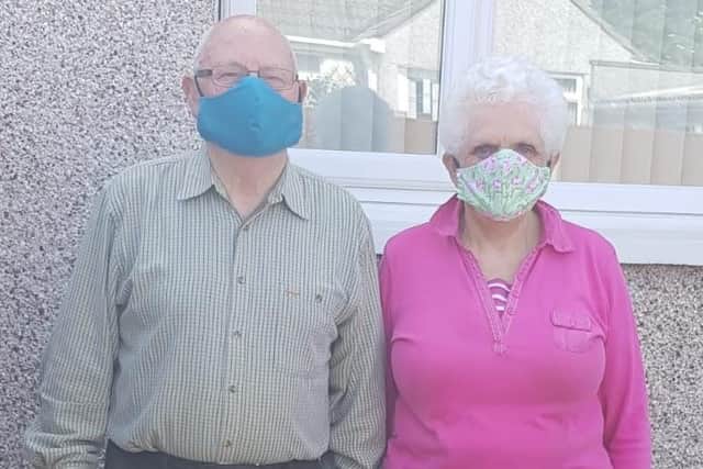 Local residents wear face masks made by Bay Leadership Academy pupils.