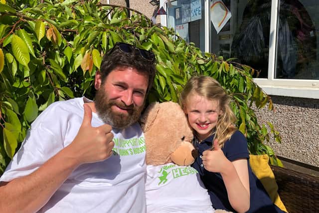 Ian and Bella Gittins giving a thumbs up on completing their sponsored silence.