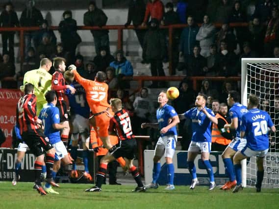 Barry Roche heads home Morecambe's equaliser against Portsmouth