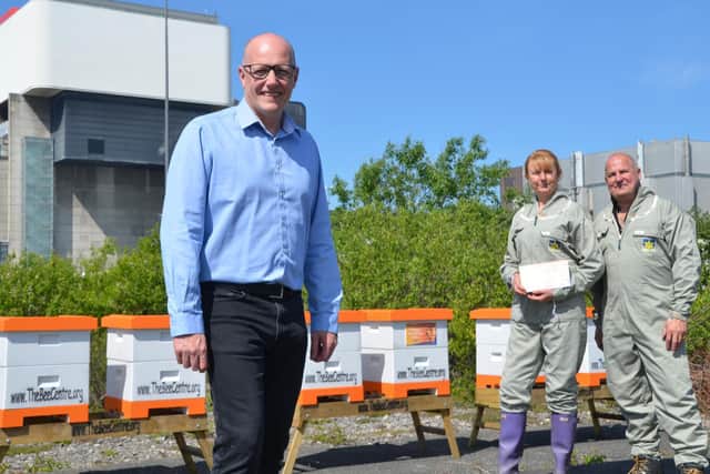 Ian Glaves, plant manager at Heysham 2 Power Station, with  Kath and Simon Cordingley of the Bee Centre