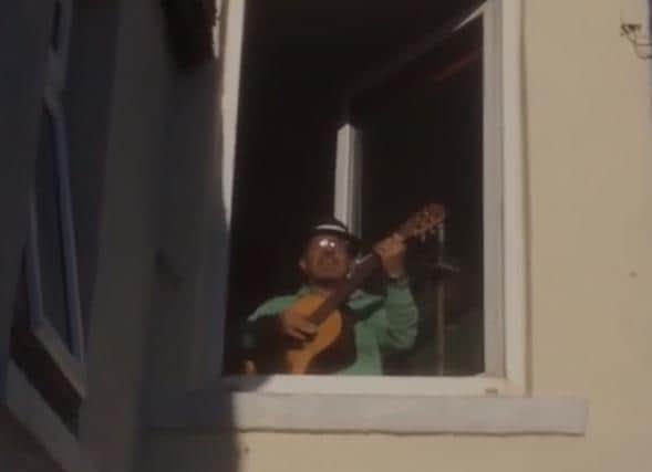 Jerry singing from an upstairs window.