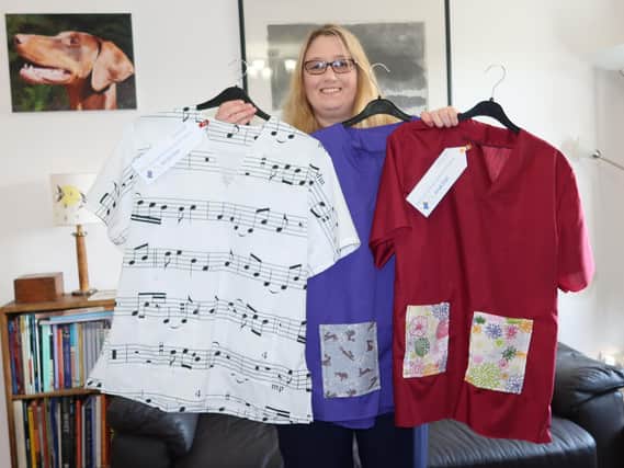 University of Cumbria Scrubs Club co-ordinator Caroline Briggs with some of her creations, including the distinctive musical scrubs.