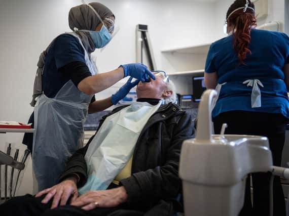 A dentist treats her first patient in PPE at St Michaels Dentist, Wakefield, West Yorkshire, as dentists open after Covid-19 lockdown. June 08 2020.   See SWNS story SWLEopen Today is the first day which dentists have been able to open after the coronavirus lockdown.
