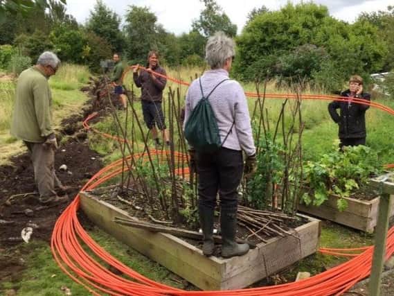 Laying cable through a garden in Halton.