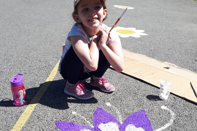 One of the Caton pupils with her painted flower.