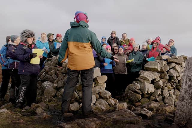 Still photograph from the film of These Hills Are Ours, an uplifting new choral performance by artist Daniel Bye, former Chumbawamba guitarist Boff Whalley and a volunteer choir from Morecambe. Picture: Bevis Bowden.
