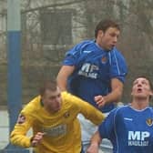 Andy Teague (centre) rises high in his first spell for Lancaster City