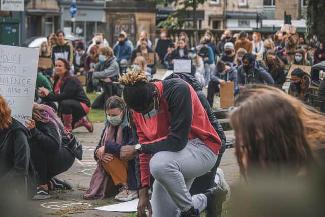 Taking the knee at the protest in Dalton Square. Photo by Tom Morbey.