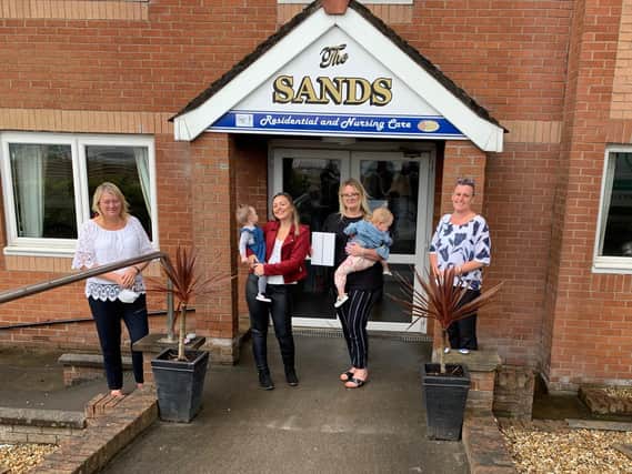 Coral Proud and Emma Pond present an iPad to the Sands Nursing Home, Morecambe.