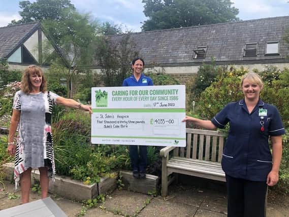 Julie Duncan (left) and daughter Natalie Duncan (centre) present a cheque for 4,033 to Head of Inpatient Services at St Johns Hospice, Lucy OConnor.