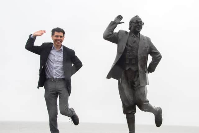 Shadow tourism minister Alex Sobel posing with the Eric Morecambe statue.