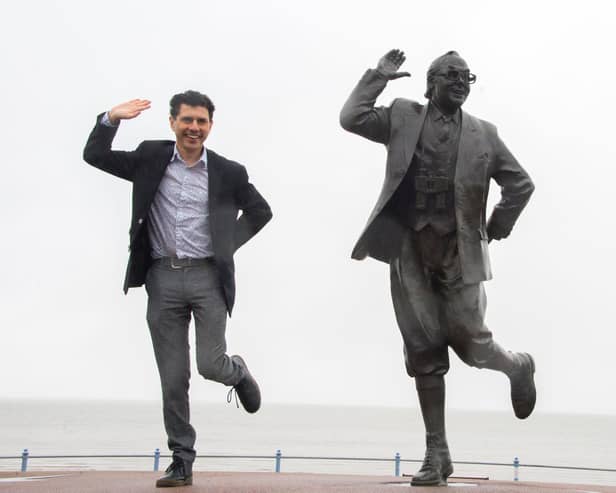Shadow tourism minister Alex Sobel posing with the Eric Morecambe statue.