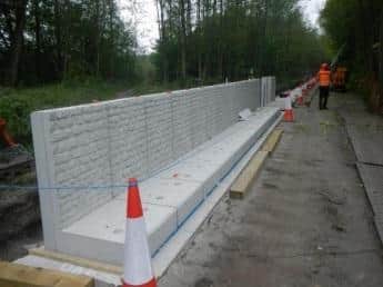 The flood wall taking shape along the Millennium Path next to the River Lune.