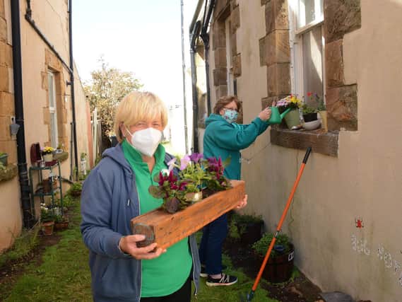 Wise Up director and volunteer Jo Gibson with local resident Ann Angus, helping to tidy up an alley in Rydal Road, Morecambe, during lockdown.