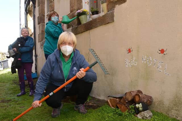 Wise Up director and volunteer Jo Gibson, front, with local residents Ann Angus and Janet Wilde, left, tidying up an alley in Rydal Road, Morecambe.