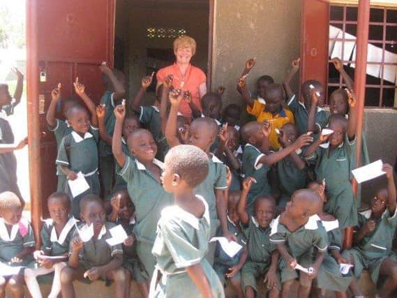 Carolyn Murray with some of the children she has helped in South Sudan.