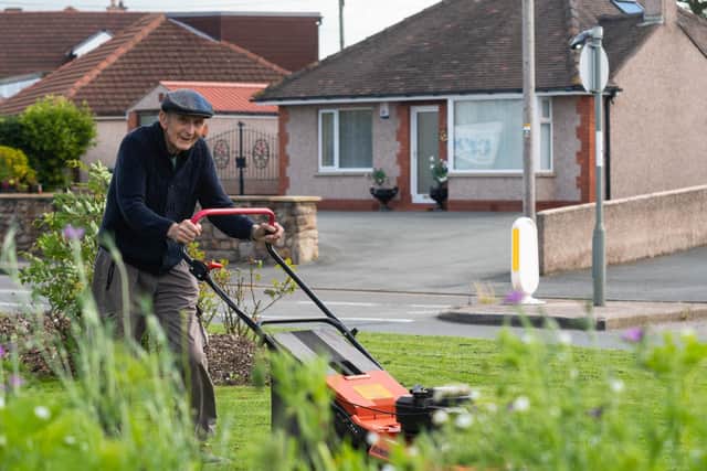 FrankGretton and other residents have been mowing the grass and looking after the flowers at TorrisholmeSquare. Photo: Kelvin Stuttard