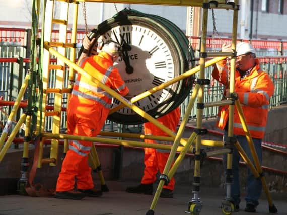 The clock being placed on a porter's trolley. Photo: Robert Swain