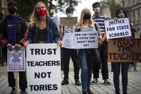 Students wearing face masks take part in a protest in Westminster in London over the government's handling of A-level results, university provision and bleak employment prospects.. Photo credit : Victoria Jones/PA Wire