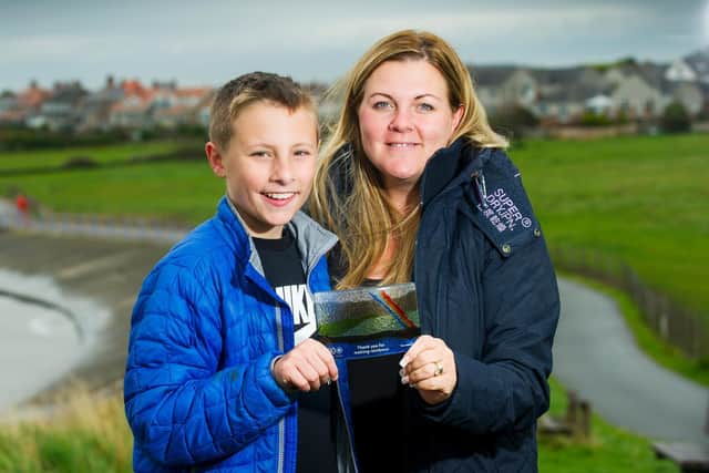 Charlie Jones and his mum Natalie with his award.