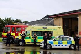 Rachel O'Neil, second from left, with members of the emergency services and their vehicles, which have been adorned with gold ribbons to mark Teenage Cancer Awareness Month.