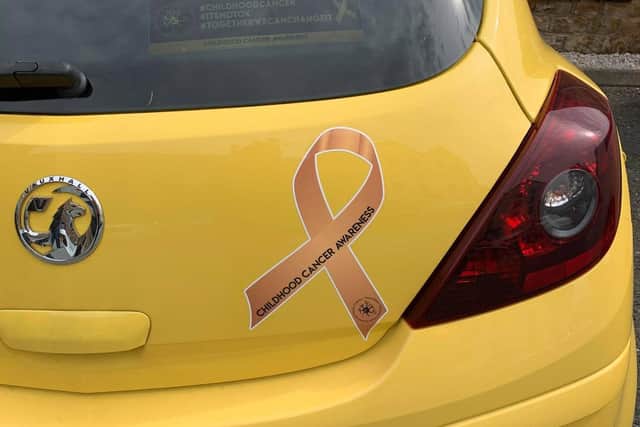 One of the Team Reece gold ribbon car stickers.