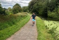 Tom running by the canal.